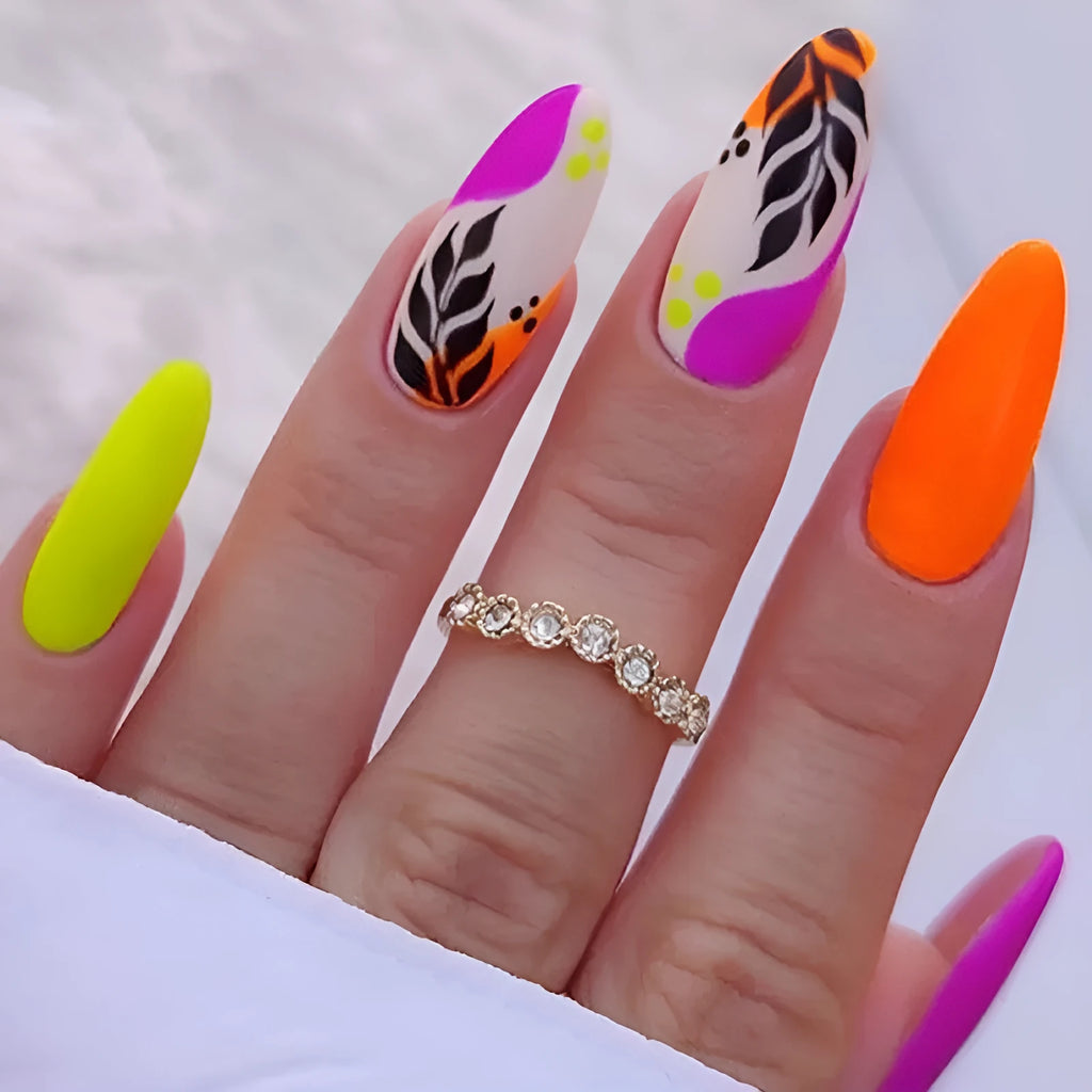 Wear Armour medium almond nail stickers showing four decorative designs including French leaves and gradient leopard print patterns