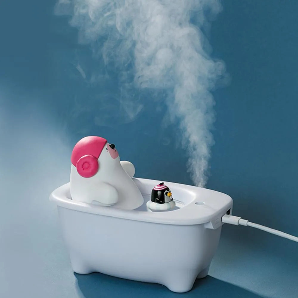 White Creative USB desktop air humidifier and scent diffuser on a wooden table.
