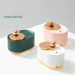 Green rotating planet-shaped USB humidifier with night light on a wooden desk