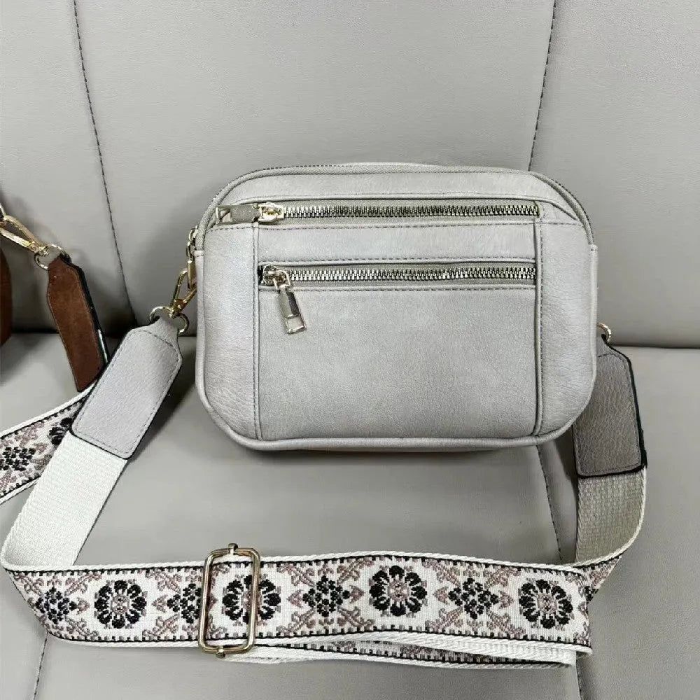 Triple-zipper shoulder bag with floral embroidered straps in colourblock finish for women