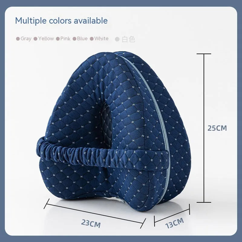 Heart-shaped dark blue jacquard memory foam leg pillow for adults on a bed.