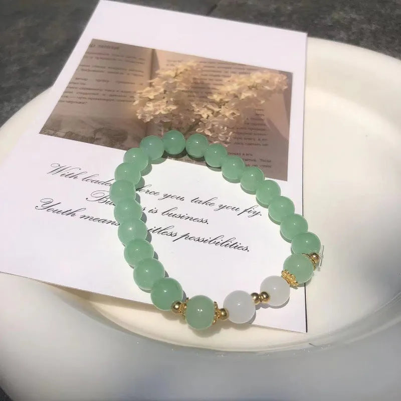 Chinese style glass bead bracelet with bamboo leaf design and manual craftsmanship details.