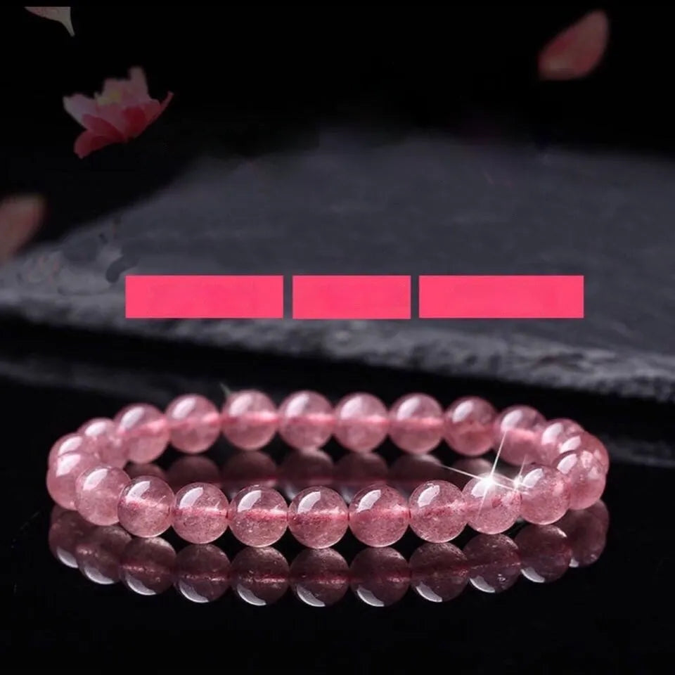 Women's strawberry quartz crystal bracelet with mixed 6mm, 8mm, and 10mm polished beads.