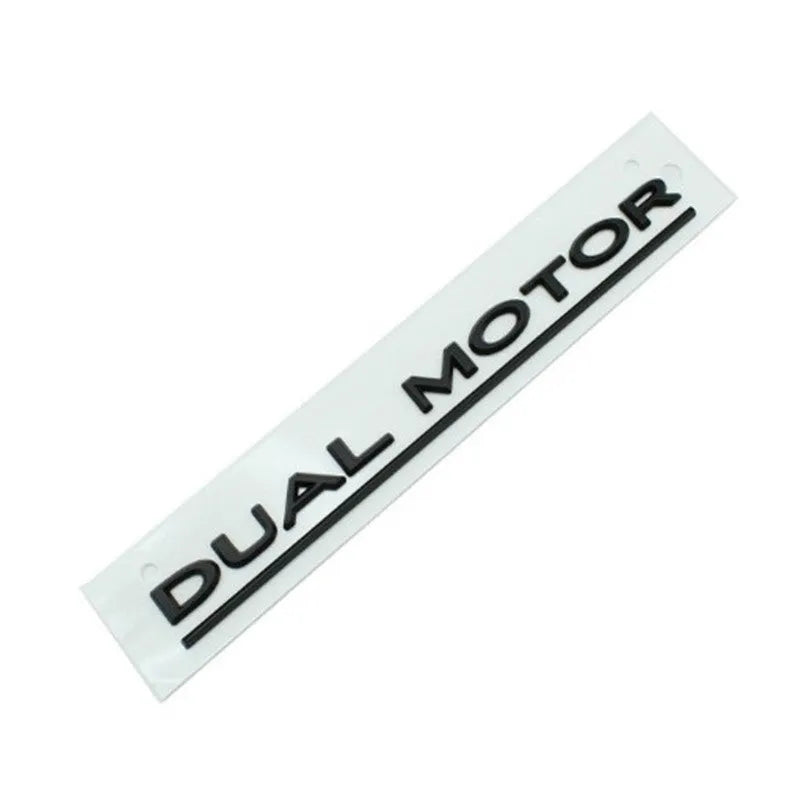 Tesla Model 3 Dual Motor bumper sticker in ABS plastic, shown in matte black with a black stripe, dimensions 19cm by 3cm.