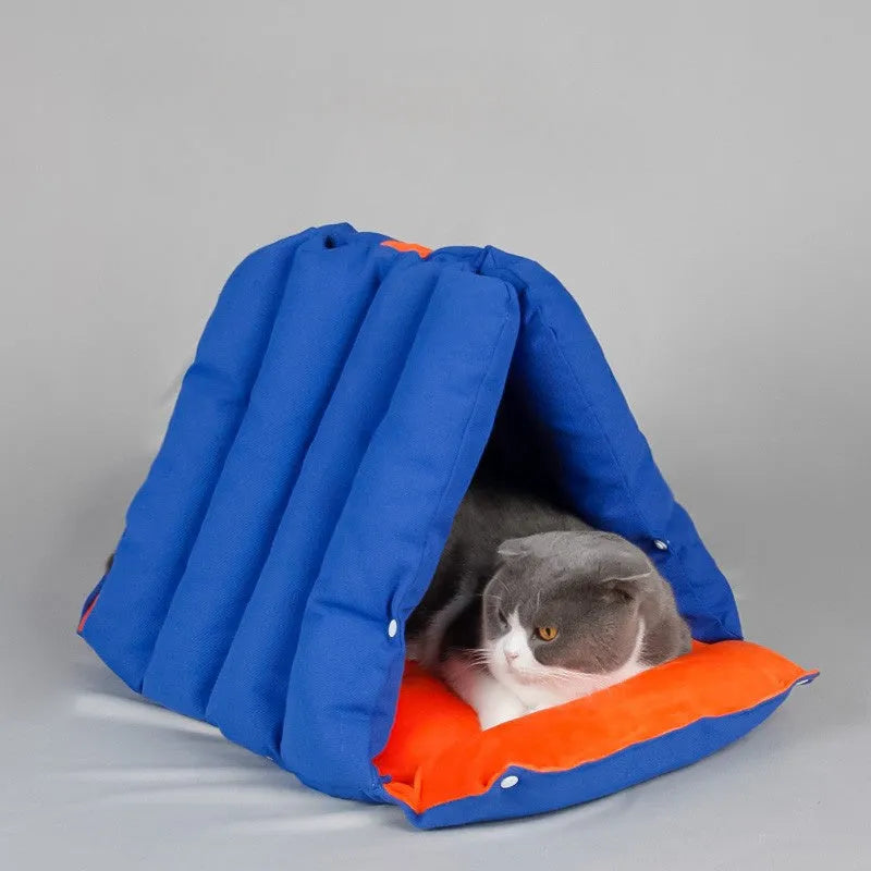 Blue triangular fabric cat bed with a sofa shape and visible connection holes on the sides.