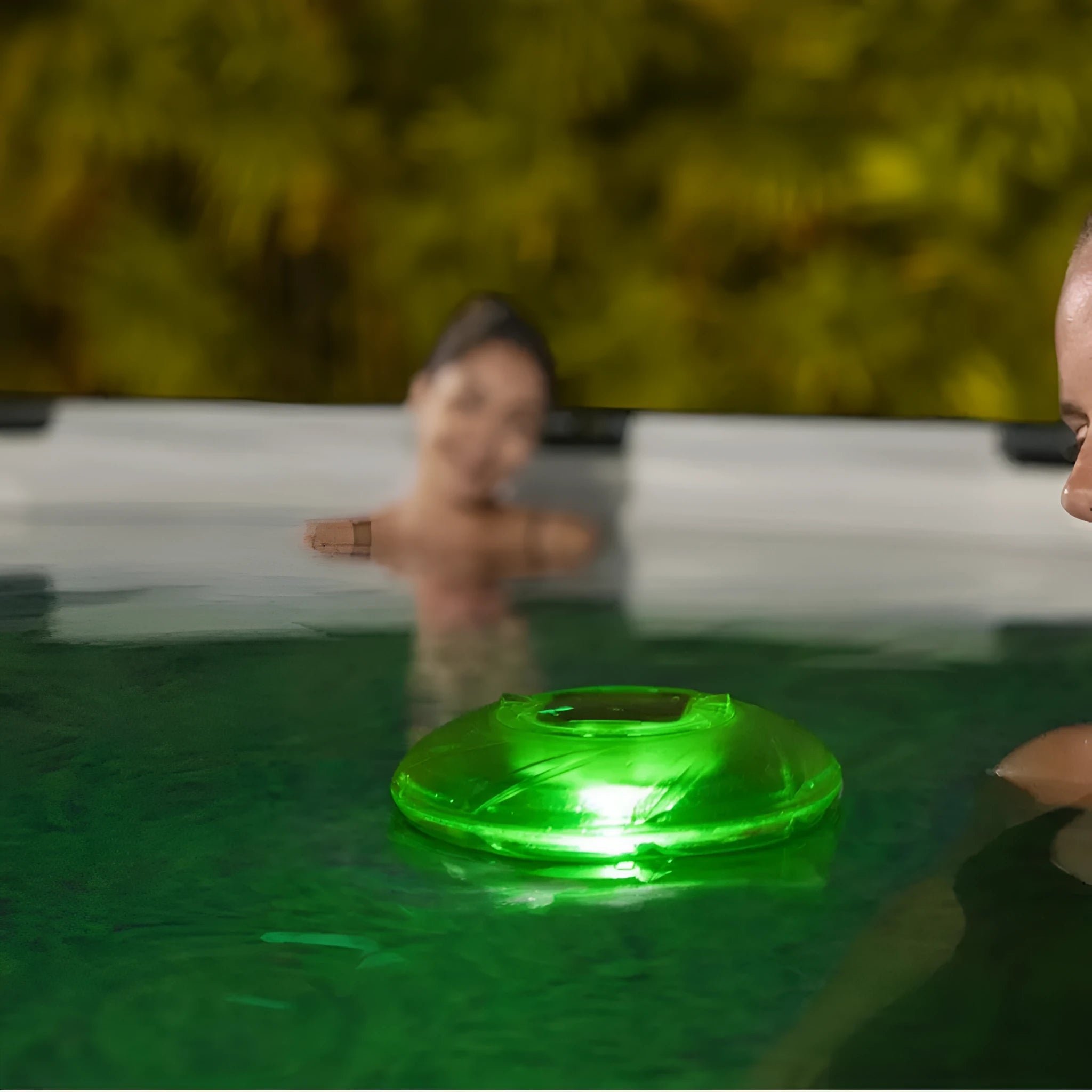 Bestway 58111 solar floating light floating on water surface in outdoor pool at dusk