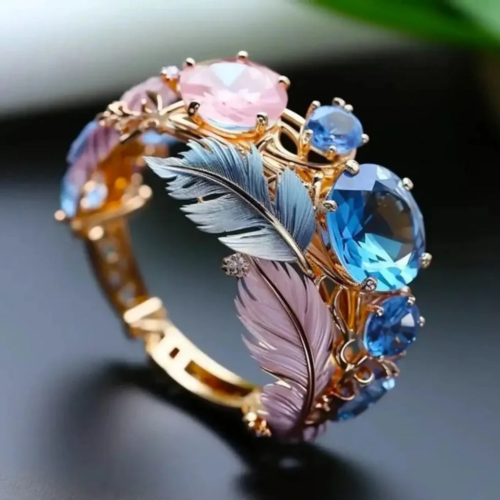 Gold-coloured brass feather ring with embossed geometric design and zircon inlay