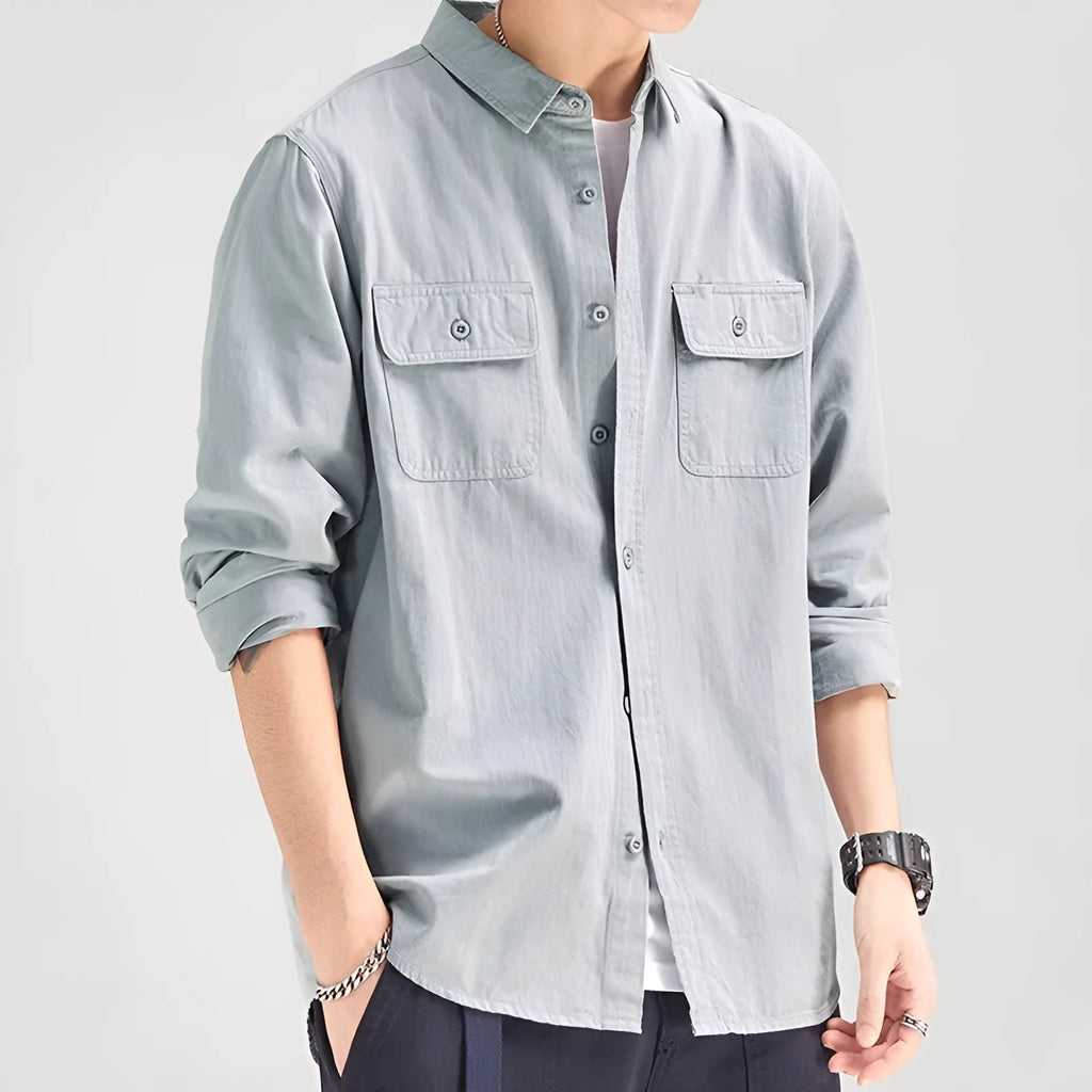 Man wearing a loose fit long sleeve cardigan shirt in light grey polyester.