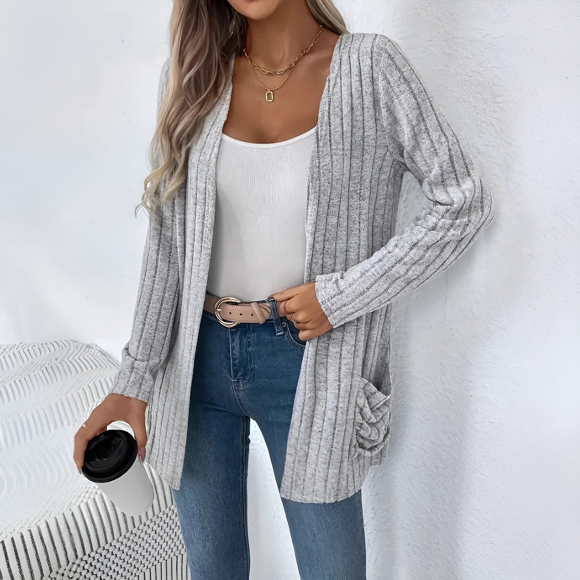 A solid colour long sleeve cardigan with pockets, shown in loose fit on a model.
