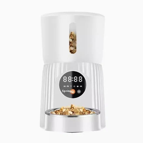 Black automatic pet feeder with digital display and food hopper on a floor
