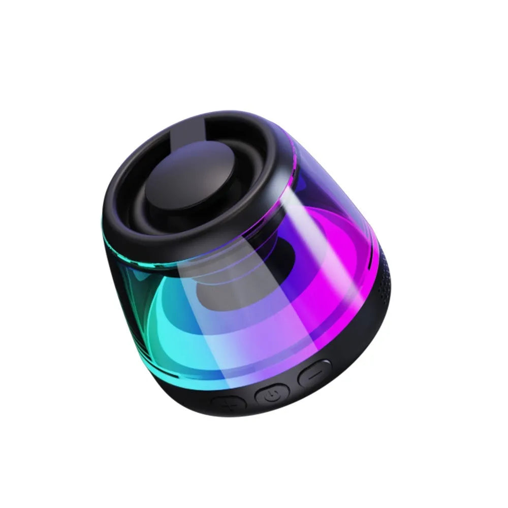 Portable white or black Bluetooth speaker with ambient lighting and magnetic design on a desktop