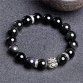 Obsidian bracelet with natural cloud pattern and silver clasp shown in male 12mm and female 10mm sizes.