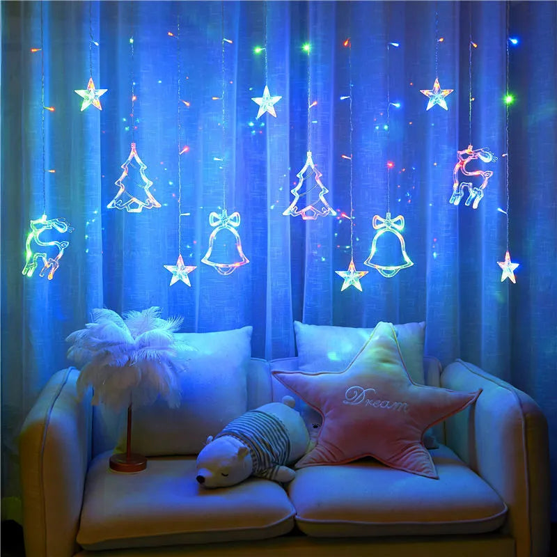 LED Christmas curtain lights with deer and tree pendants in warm white on a window