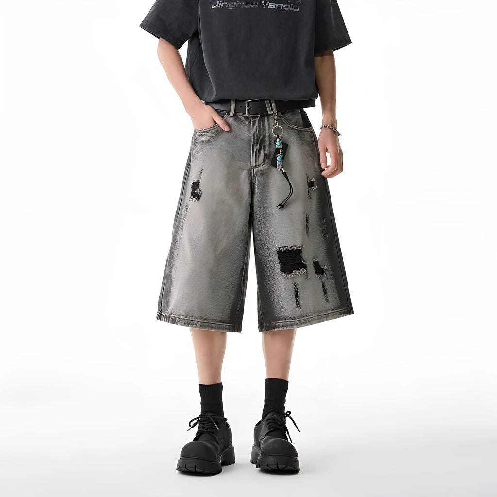 Grey distressed denim shorts with water washed finish and loose retro fit