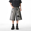 Grey distressed denim shorts with water washed finish and loose retro fit