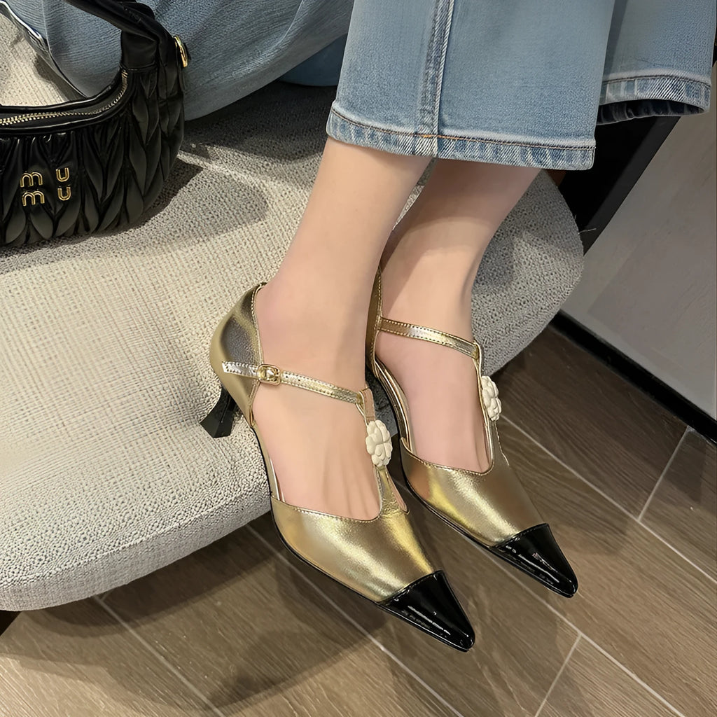 Women's black pointed toe stiletto shoe with flower buckle detail on a sheepskin upper.
