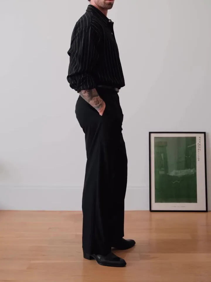 Black pinstriped button-down shirt with regular fit on a model.