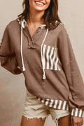 Straw yellow hoodie with waffle texture and striped patchwork design, showing front drawstring and button neck.