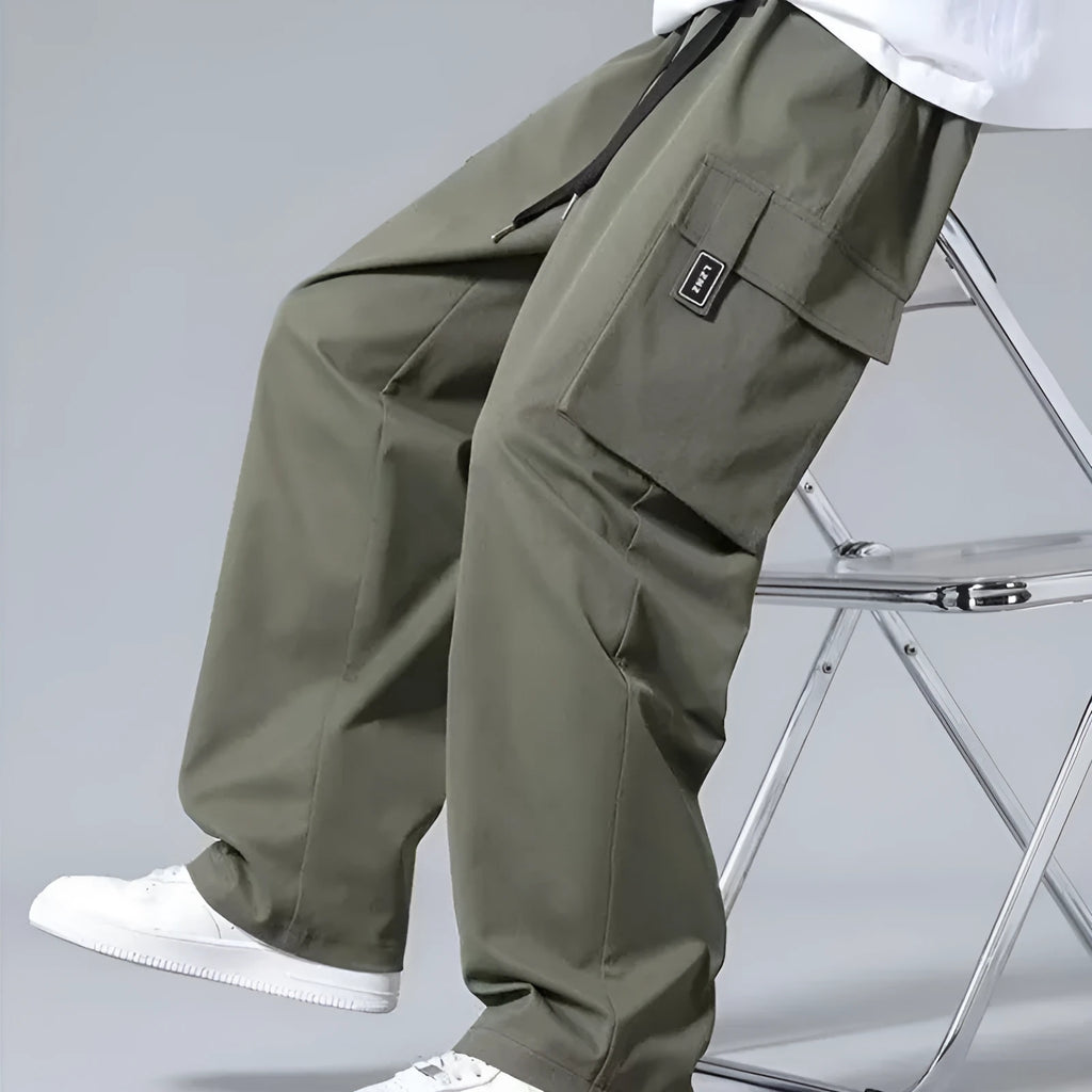 Boys straight leg cargo pants in army green with large pockets and a drawstring waist.