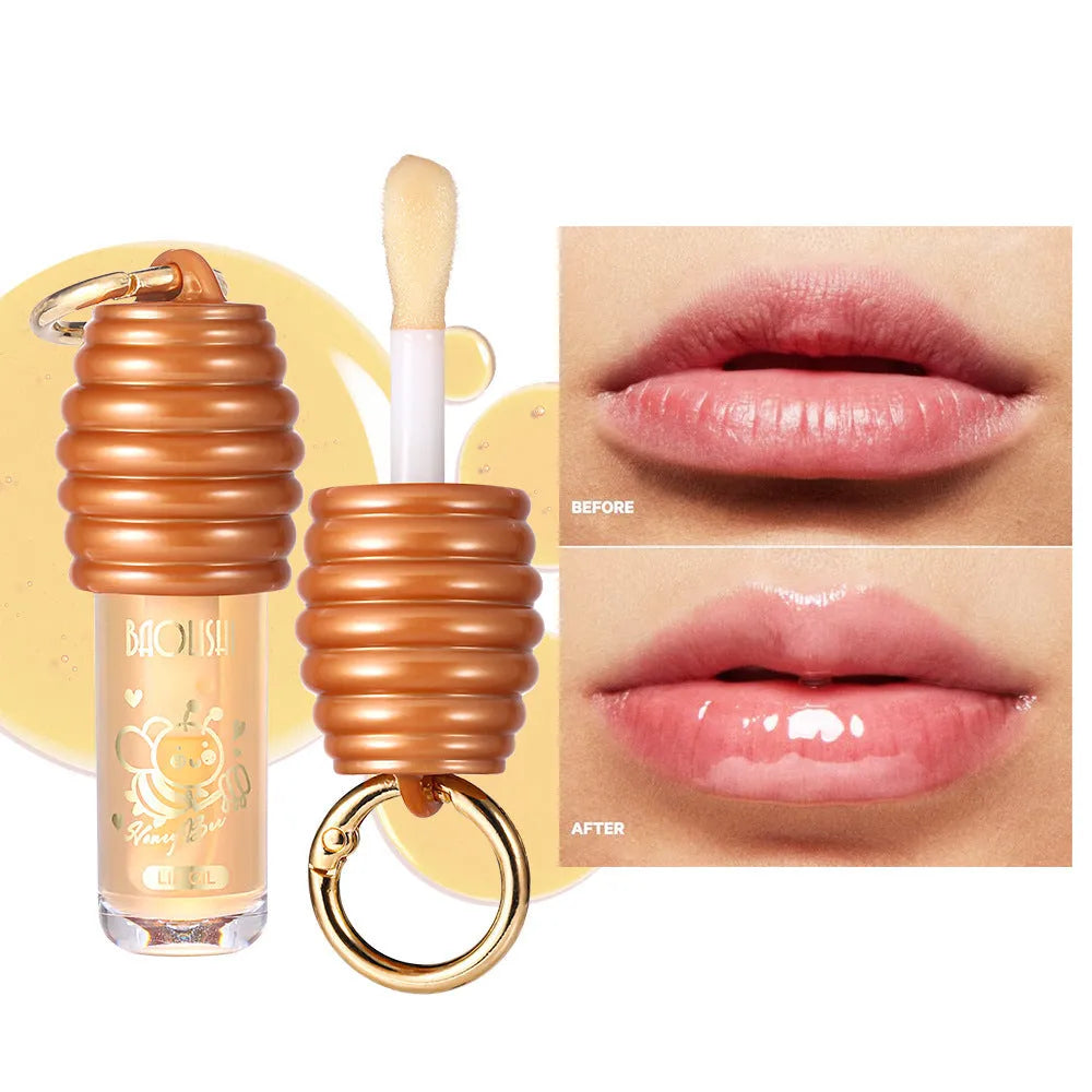 Honey lip gloss on a silver keychain clip against a neutral background.