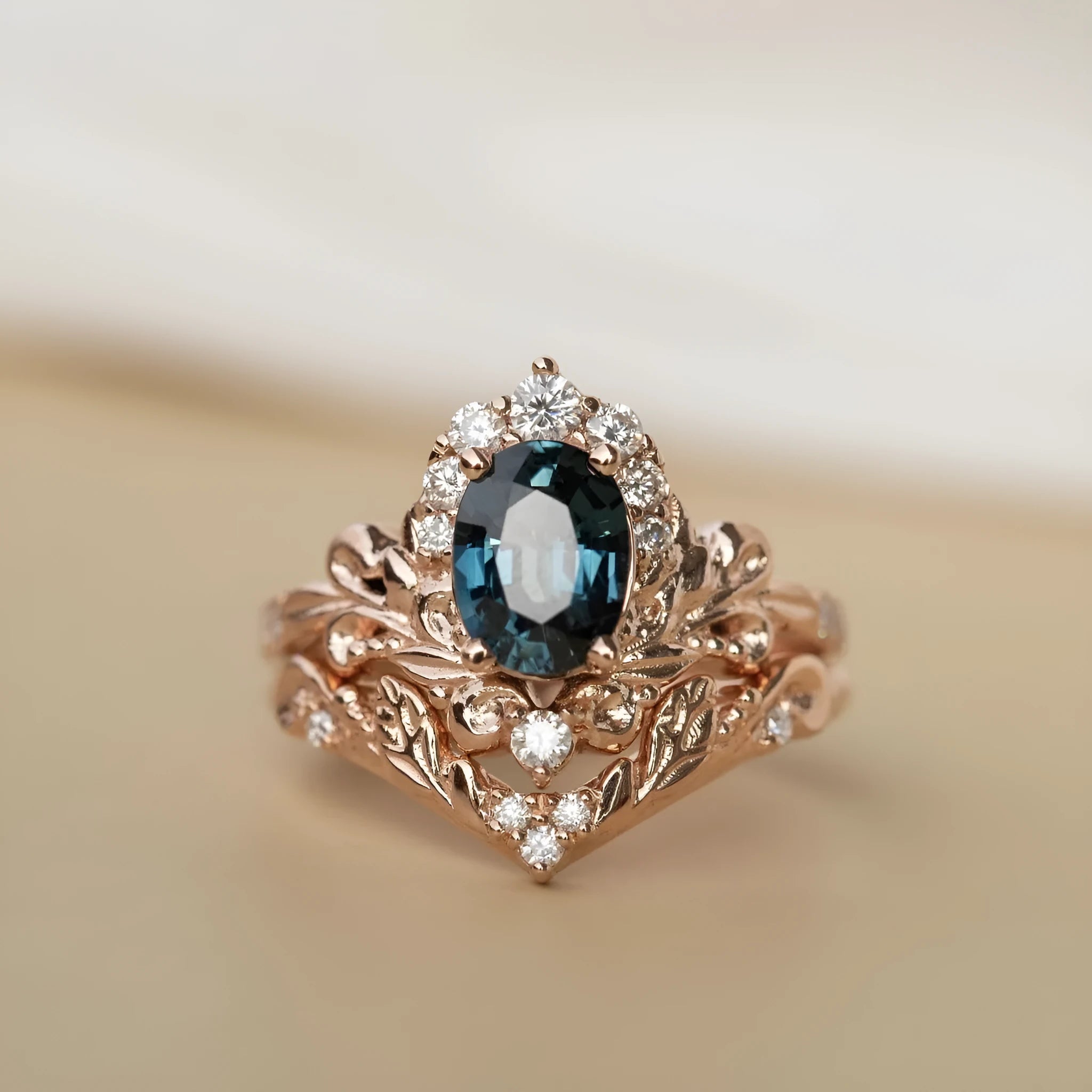 Women's rose gold branch flower ring with inlaid blue crystal, alloy construction, side view on finger