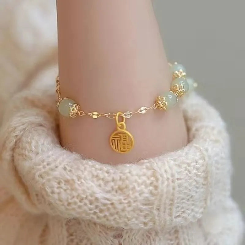 Chinese style glass bead bracelet with bamboo leaf design and manual craftsmanship details.