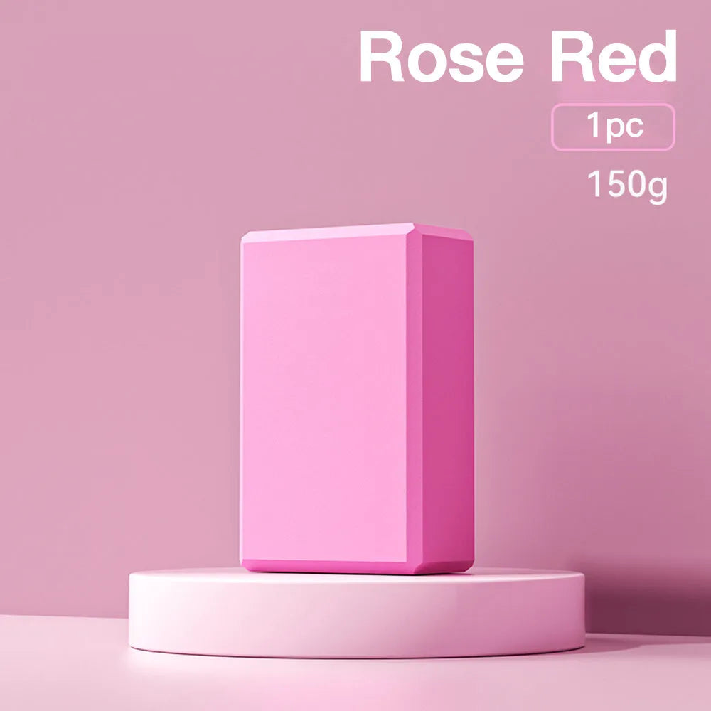 Solid colour EVA foam yoga block on a gym mat, showing its rectangular shape and ridged sides.