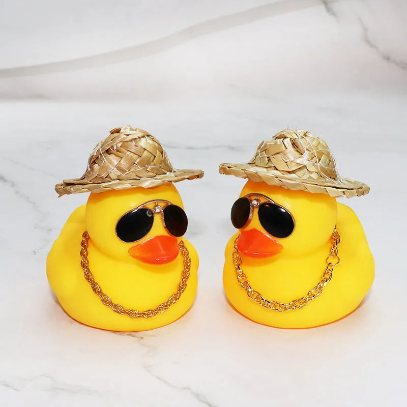 Yellow cartoon duck with straw hat car ornament on dashboard with sunglasses accessory