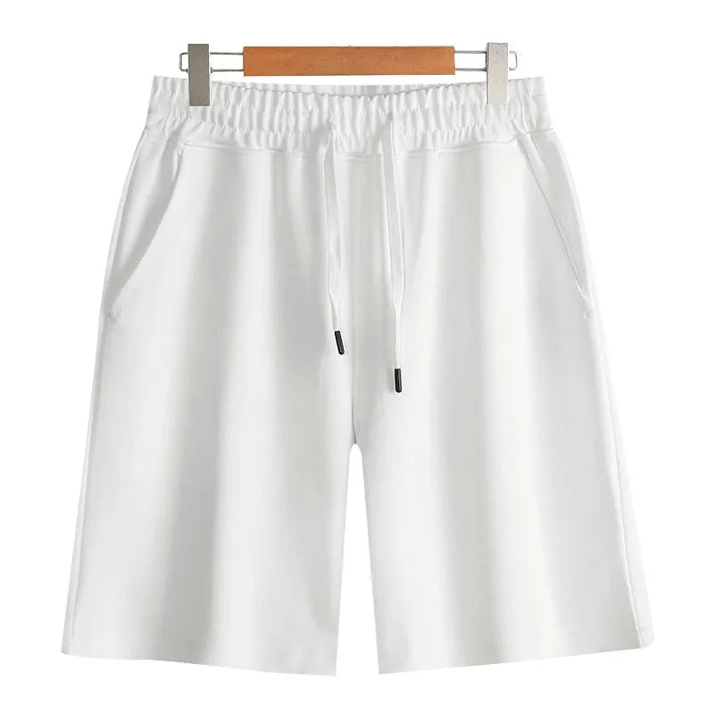 Men's and women's straight cut cotton sports shorts in multiple colours on a plain background.