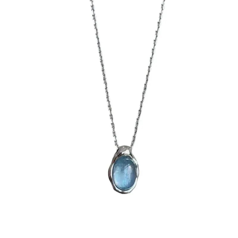 Navy blue water drop necklace with platinum accents on adjustable cross chain