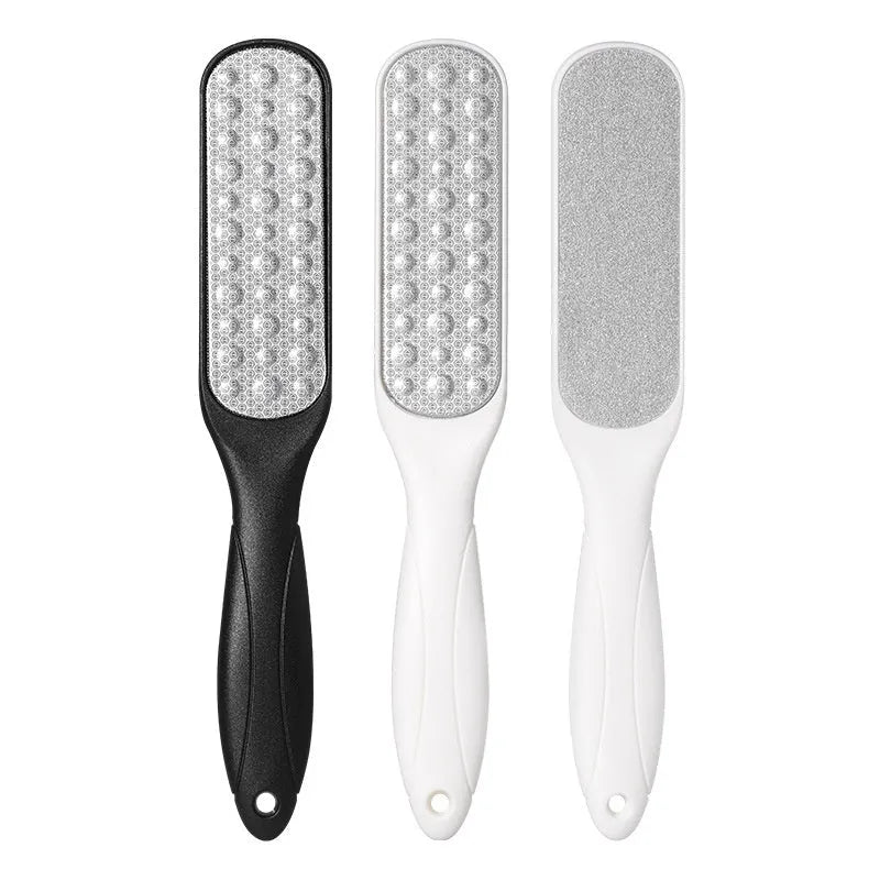 Stainless steel foot grinder with white and black double-sided abrasive attachments for foot care