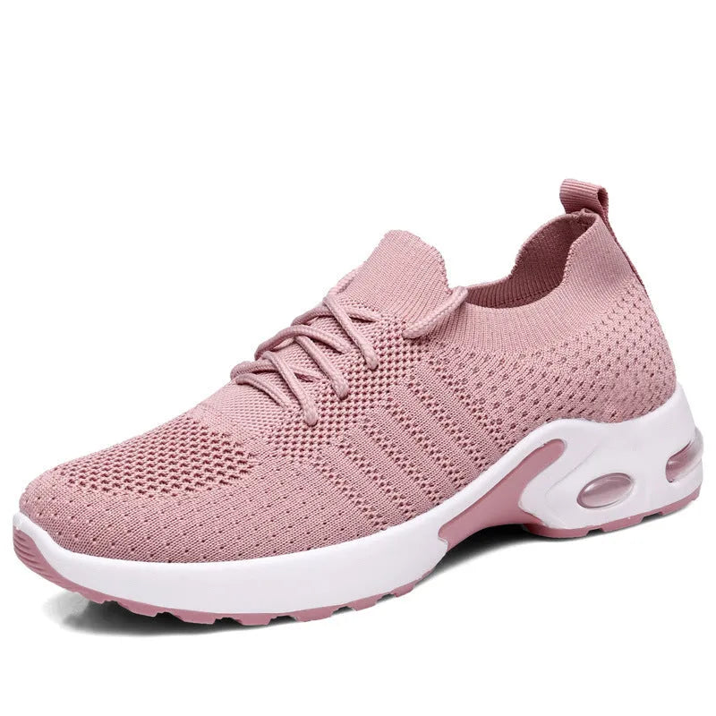 Women's black mesh casual sneakers with round toe and lace-up front on a grey background.