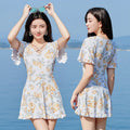 Women's high-waist one-piece swimsuit with floral print in blue and white.
