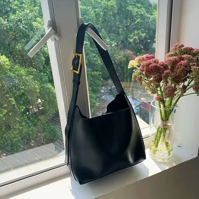 Ladies' shoulder bag with swing thread details in soft PU material showing black and brown colour options