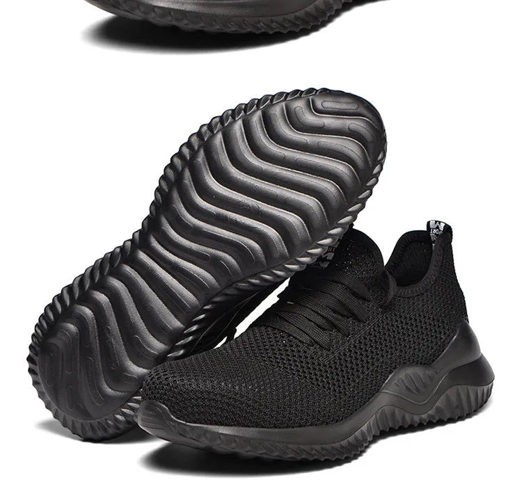 Men's black steel toe safety shoes with low-cut design on a work surface