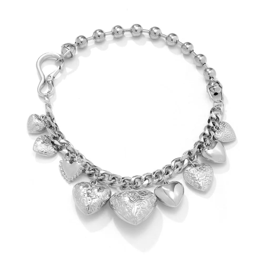 Exaggerated carved heart-shaped pendant necklace on an adjustable metal chain, shown in a gold colour finish.