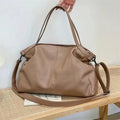 Large soft white PU messenger bag with a long cross-body shoulder strap and zip closure