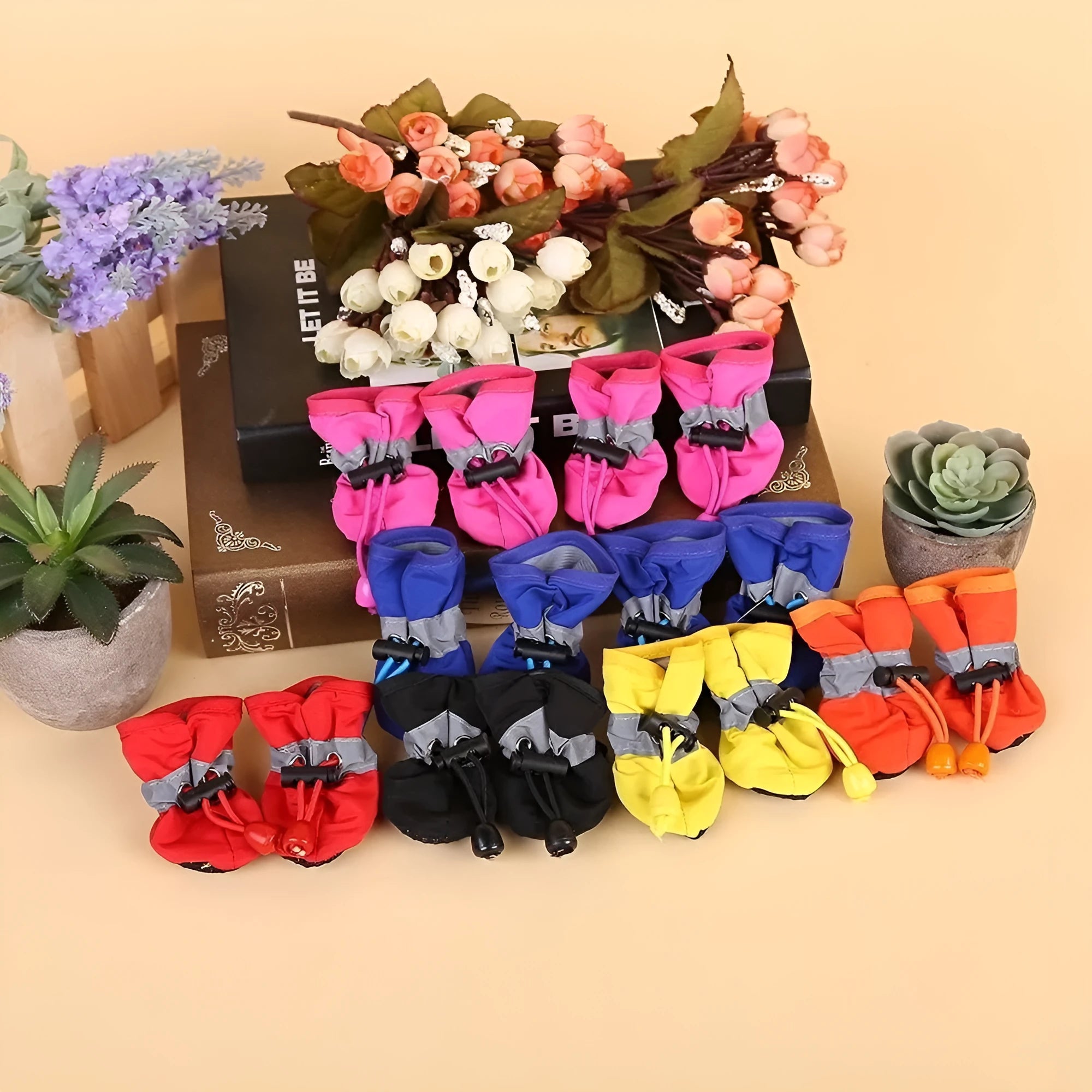 Set of four soft-soled cloth dog shoes for pets in assorted colours including red, blue, and black.