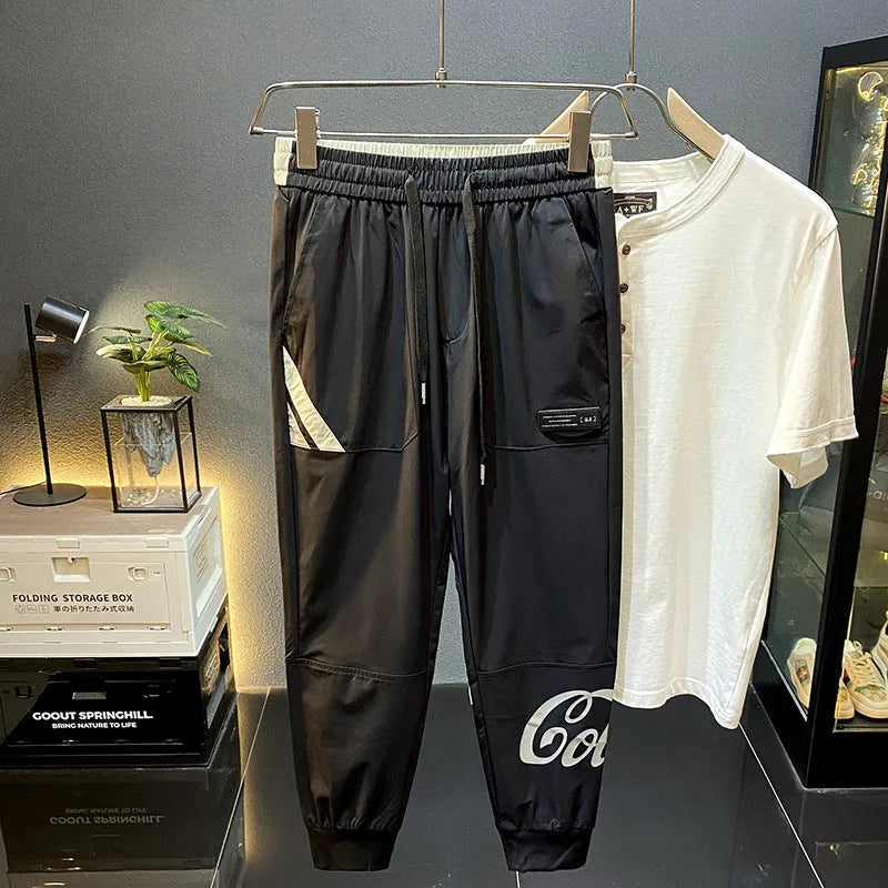 Man modelling black ultra-thin ice silk ankle banded casual cropped trousers.