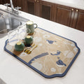 Square diatomite PVC kitchen draining mat in Camellia purple on a countertop