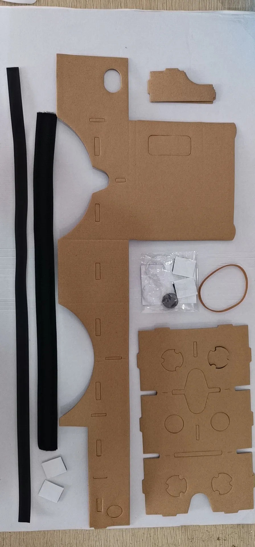 Pink and white VR Cardboard Glasses headset for 6-inch smartphones on a table.