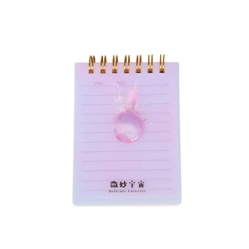 Rollover coil spiral bound pocket notepad with PP cover in Constellation design, shown open and laying flat.