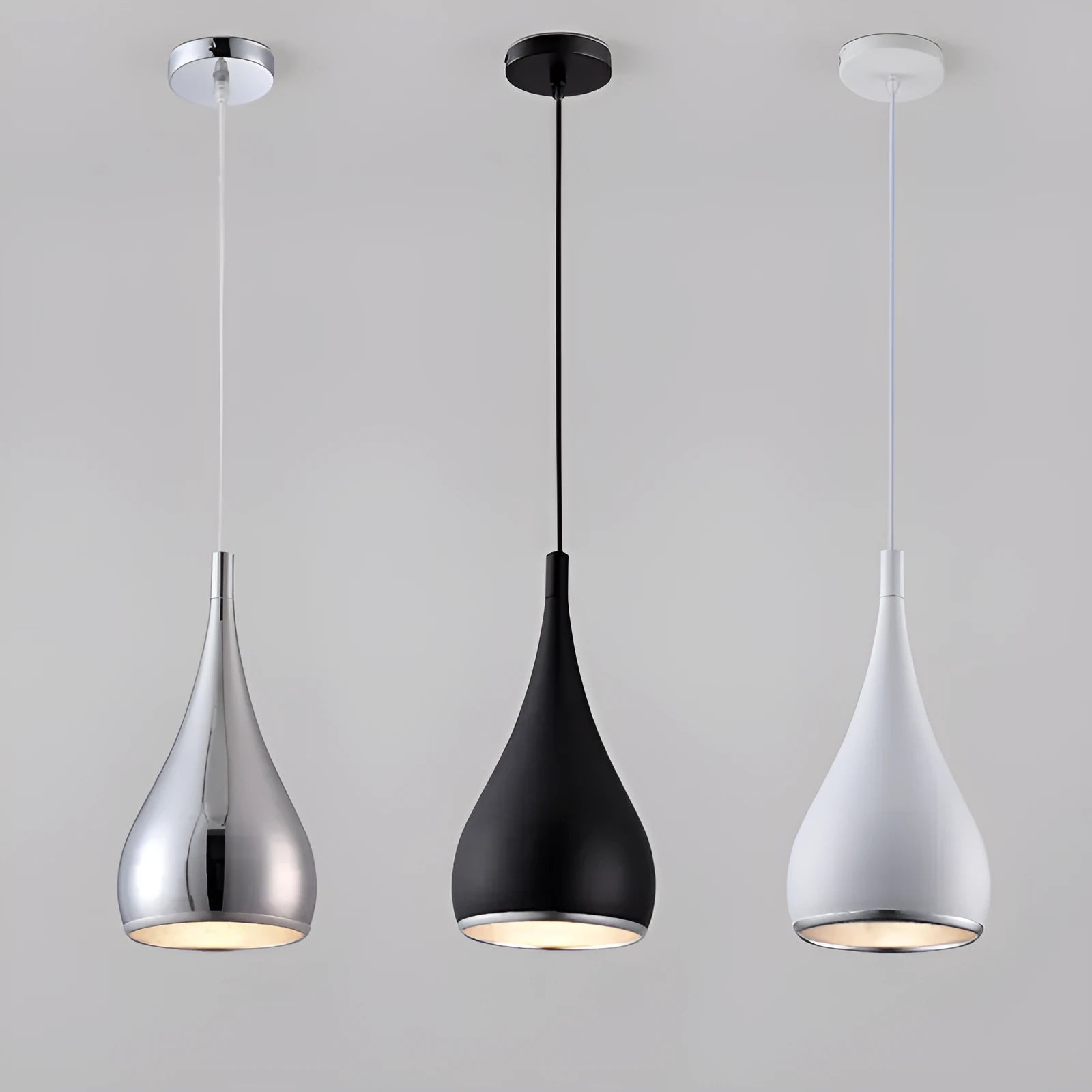 Minimalist iron chandelier in black finish with three bulb heads on a long platter base.