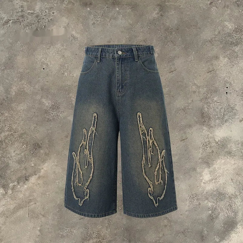 Men's black denim shorts with cropped patch flame embroidery design and straight-leg fit