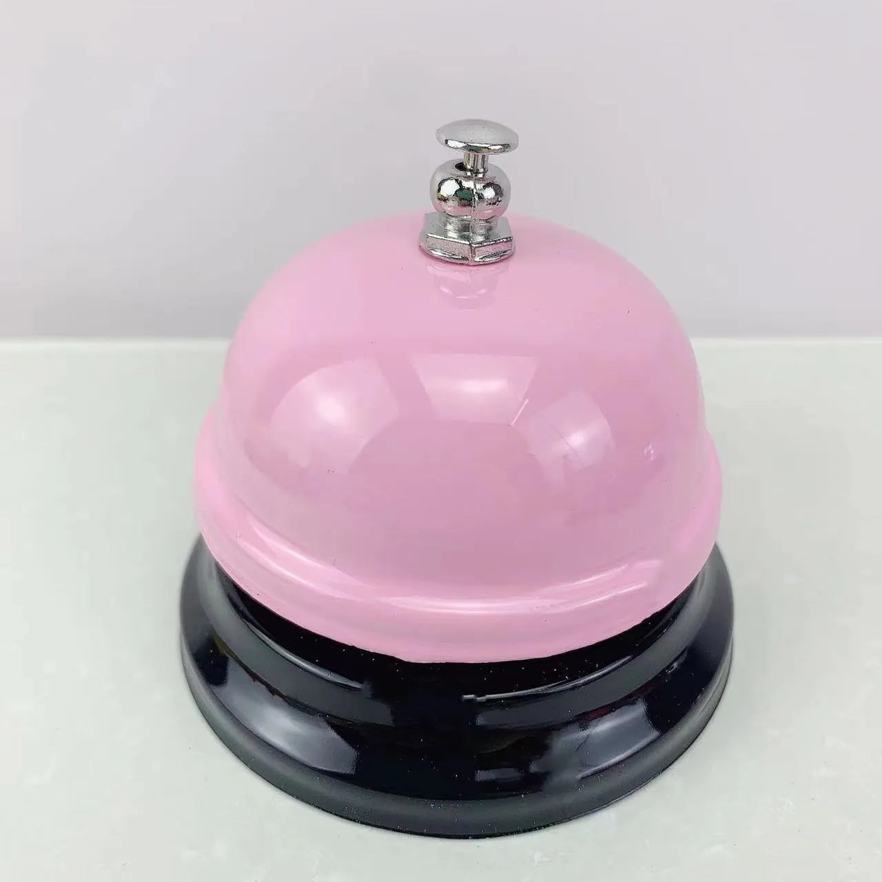 Iron game bell shown in one of ten available colours: blue, green, pink, red, yellow, green tea, or rose kiss.