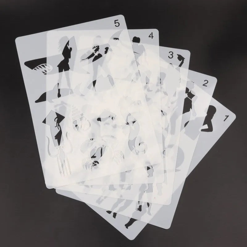 White plastic drawing stencil set with cut-out patterns for craft tracing.