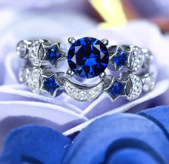 Creative moon ring with blue gemstone inlay on display showing detailed crescent design and stone setting.