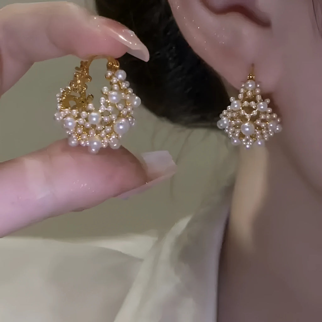 Gold-coloured copper flower basket earrings with small pearl-inlaid beads.