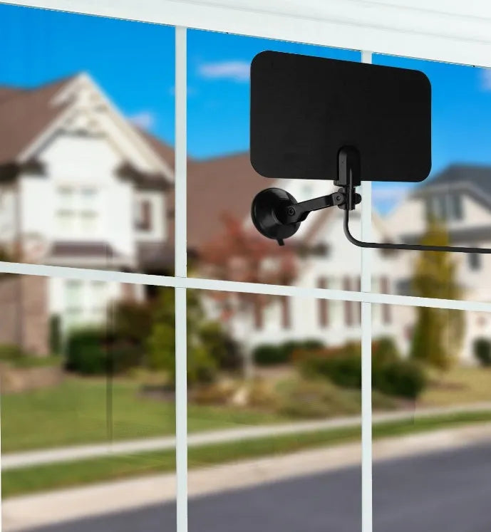 Indoor digital TV antenna for DVB-T DVB-T2 HDTV reception with EU plug option on a table near a television