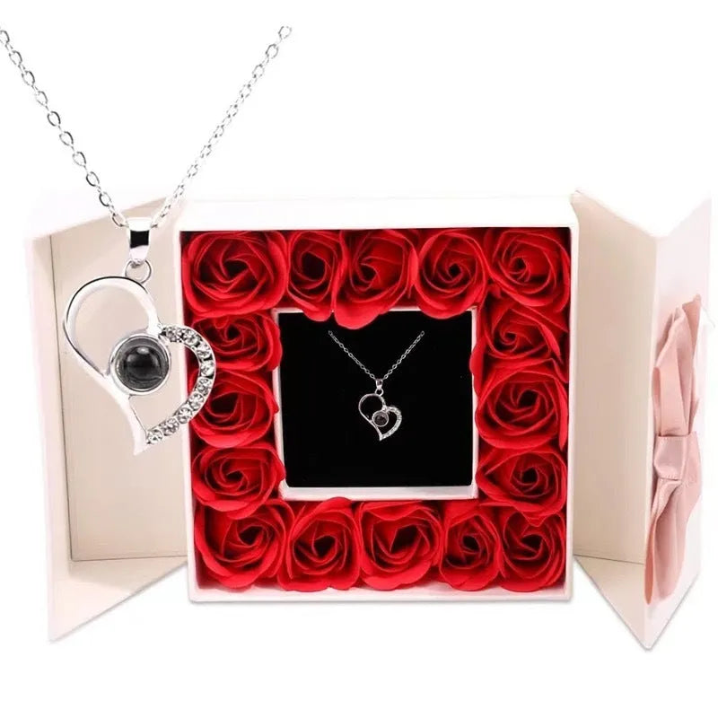 Rose gold heart-shaped projection necklace in copper with O chain, displaying 100 languages love message.